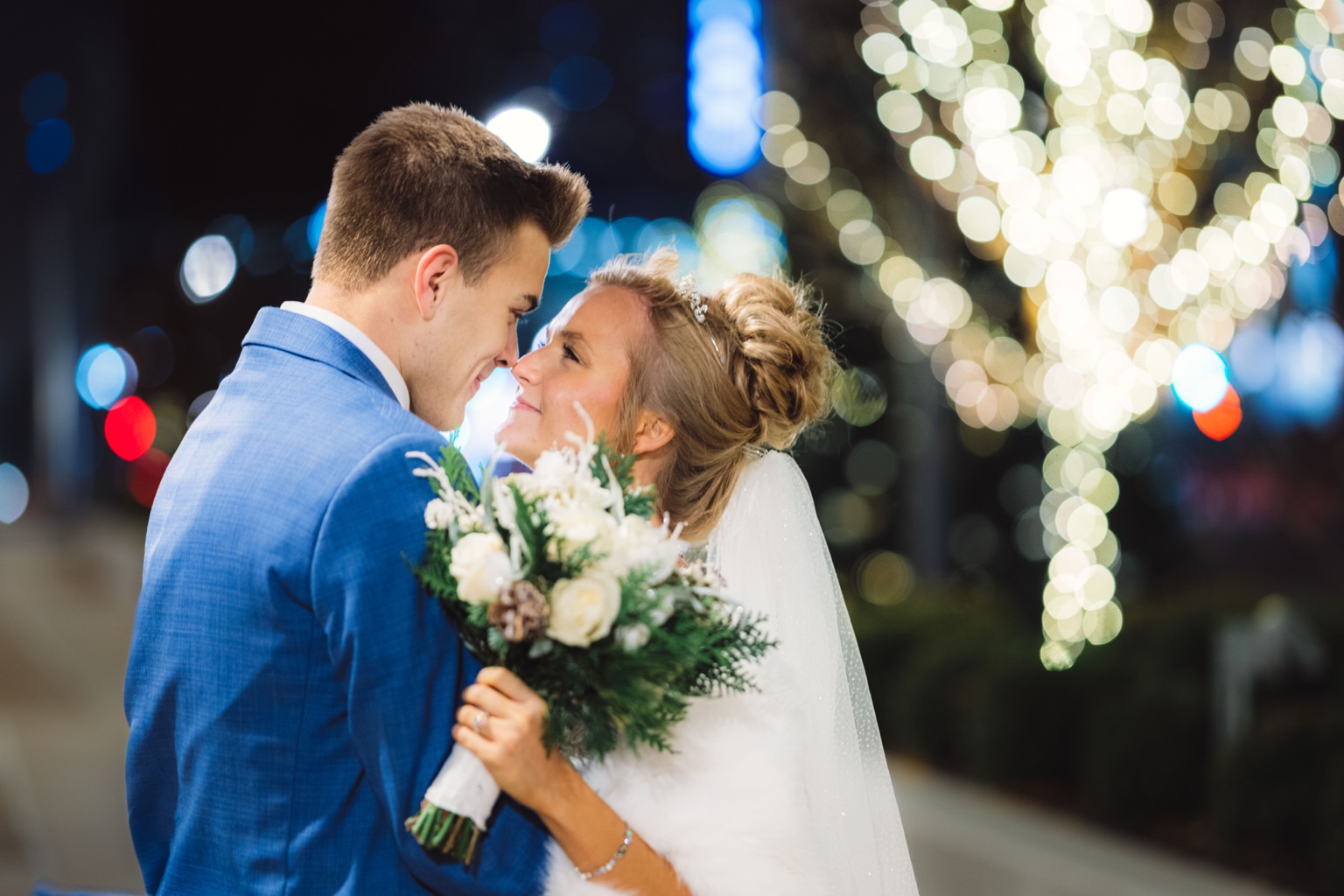 Wedding couple beneath city lights
